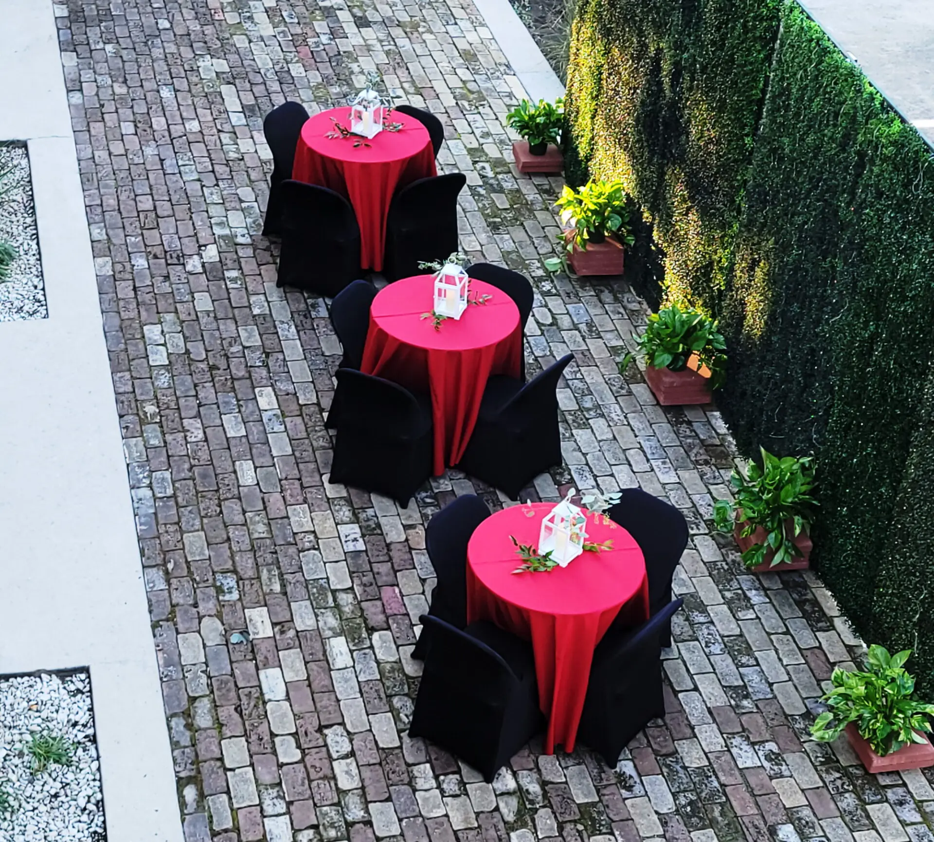 Cocktail tables on the brick patio beside the fire station