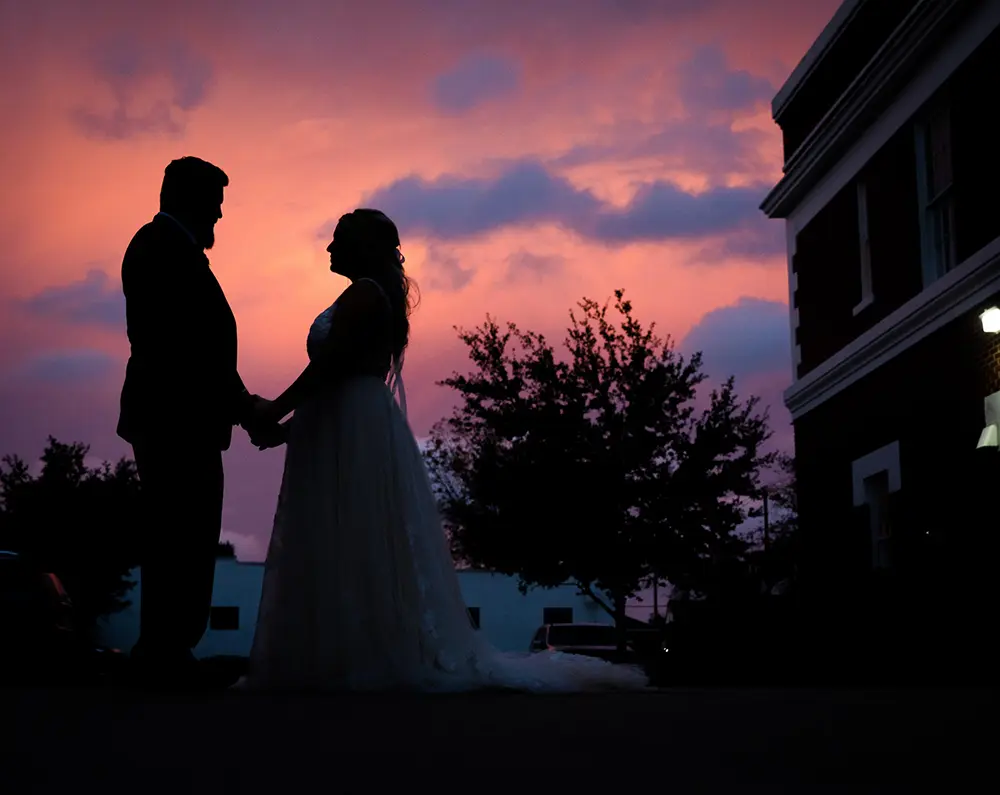 A couple silhouetted at sunset