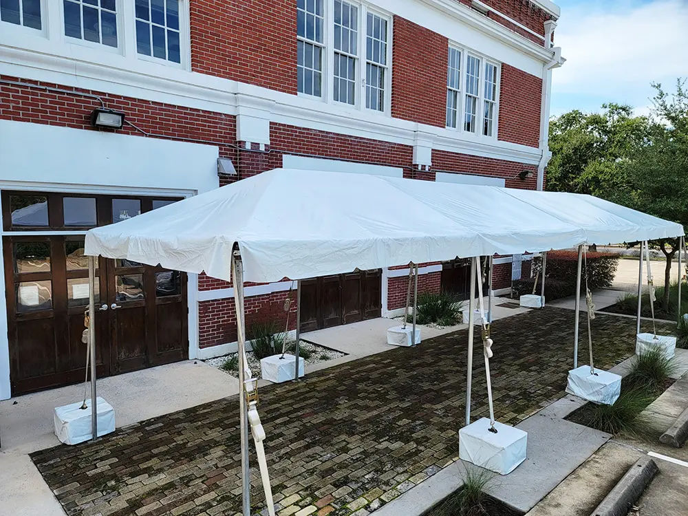 A tent and tables on the outdoor patio